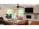 Living room featuring a brick fireplace, hardwood floors, and large windows with natural light at 1310 Larkview Sw Dr, Lilburn, GA 30047