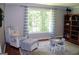 Cozy living room featuring a comfortable chair, a large window with view, and a table at 1310 Larkview Sw Dr, Lilburn, GA 30047