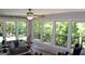 Sunroom with a seating area, large windows providing natural light, and wooded views at 1310 Larkview Sw Dr, Lilburn, GA 30047