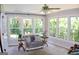 Sunroom with a seating area, large windows providing natural light, and views of backyard at 1310 Larkview Sw Dr, Lilburn, GA 30047