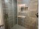 Modern bathroom featuring a tiled shower with shelving at 1012 Institute Nw St, Conyers, GA 30012