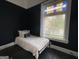 Serene bedroom featuring black walls, a comfortable bed, and a window at 1012 Institute Nw St, Conyers, GA 30012