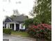 Charming blue house with a welcoming porch and beautiful rose bushes at 1012 Institute Nw St, Conyers, GA 30012