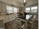 Well-lit kitchen featuring white cabinets, modern appliances, and a kitchen island at 1012 Institute Nw St, Conyers, GA 30012