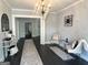 Spacious living room featuring an elegant chandelier, seating, and open doorways at 1012 Institute Nw St, Conyers, GA 30012