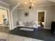 Elegant living room featuring dark wood floors, chandelier, and seating area at 1012 Institute Nw St, Conyers, GA 30012