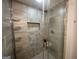 Modern tiled shower with glass door and built-in niche, enhancing the bathroom's appeal at 1012 Institute Nw St, Conyers, GA 30012