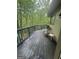 Unwind on the back deck, featuring a chair and small table, with a view of the private wooded surroundings at 2532 N Carroll Ct, Villa Rica, GA 30180