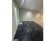 Basement area showing a transition between black tiled and carpeted flooring at 2532 N Carroll Ct, Villa Rica, GA 30180
