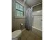 Bathroom with tiled floor and white tub with grey shower curtain at 2532 N Carroll Ct, Villa Rica, GA 30180