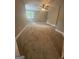 Spacious carpeted bedroom with large window and neutral paint at 2532 N Carroll Ct, Villa Rica, GA 30180