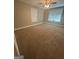 Bright bedroom with neutral walls, plush carpet, and plenty of natural light from two windows at 2532 N Carroll Ct, Villa Rica, GA 30180