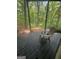 Relaxing outdoor deck space with chair overlooking a lush, wooded backyard view at 2532 N Carroll Ct, Villa Rica, GA 30180