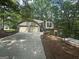 Exterior view of house featuring a two car garage and lovely front yard at 2532 N Carroll Ct, Villa Rica, GA 30180