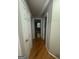 Hallway boasts wood flooring, neutral paint and white doors at 2532 N Carroll Ct, Villa Rica, GA 30180