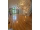 Bright, open living room with hardwood floors, fireplace, large windows, and high ceilings at 2532 N Carroll Ct, Villa Rica, GA 30180