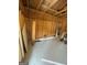 Inside the shed, showcasing its storage capabilities, wood paneling, and concrete flooring at 2532 N Carroll Ct, Villa Rica, GA 30180