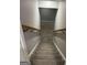 Carpeted staircase with wooden handrail ascends to the upper level at 2532 N Carroll Ct, Villa Rica, GA 30180