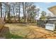 Spacious backyard featuring a patio, large deck, mature trees, and a stone fire pit area at 456 Pretty View Se Ln, Smyrna, GA 30082