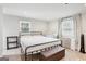 Bedroom features a queen bed frame, plush carpeting, and natural light from windows, offering a cozy retreat at 456 Pretty View Se Ln, Smyrna, GA 30082