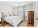 This bedroom is bright and airy with natural light, ceiling fan, hardwood floors, and an area rug at 456 Pretty View Se Ln, Smyrna, GA 30082