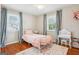 Bedroom with hardwood floors, ample natural light, a vanity, and a rug, creating a cozy, inviting space at 456 Pretty View Se Ln, Smyrna, GA 30082