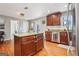 Gourmet kitchen with stainless steel appliances, cherry cabinets, an island, and tile backsplash at 456 Pretty View Se Ln, Smyrna, GA 30082