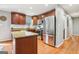 Spacious kitchen with cherry cabinets, stainless steel appliances, and a center island for culinary enthusiasts at 456 Pretty View Se Ln, Smyrna, GA 30082