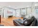 Inviting living room featuring hardwood floors, natural light, neutral paint, and an entertainment center at 456 Pretty View Se Ln, Smyrna, GA 30082