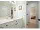 Bright bathroom featuring a white vanity, updated fixtures, and a view into an adjacent bedroom at 6017 Chestatee Creek Nw Ct, Acworth, GA 30101
