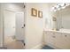 Well-lit bathroom with a white vanity, updated fixtures, and tile flooring, showcasing functionality at 6017 Chestatee Creek Nw Ct, Acworth, GA 30101