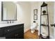 This bathroom features wood floors, a single vanity and a modern toilet at 6017 Chestatee Creek Nw Ct, Acworth, GA 30101