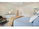 Bright bedroom with neutral walls, ceiling fan, bedside table, and large window at 6017 Chestatee Creek Nw Ct, Acworth, GA 30101