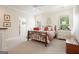 Comfortable bedroom with natural light, neutral carpet, queen-sized bed, and bedside table at 6017 Chestatee Creek Nw Ct, Acworth, GA 30101