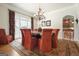 Charming dining room with a round table, seating for eight, chandelier, and access to the kitchen at 6017 Chestatee Creek Nw Ct, Acworth, GA 30101