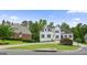 Charming two-story white brick home with black shutters features a well-manicured lawn and a circular driveway at 6017 Chestatee Creek Nw Ct, Acworth, GA 30101