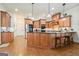 Well-lit kitchen featuring an island with barstool seating, stainless steel appliances, and hardwood floors at 6017 Chestatee Creek Nw Ct, Acworth, GA 30101