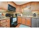 Well-equipped kitchen with stainless steel appliances, tile backsplash, and ample cabinet space at 6017 Chestatee Creek Nw Ct, Acworth, GA 30101