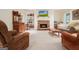 Inviting living room with a stone fireplace, TV, and built-in shelves for décor and storage at 6017 Chestatee Creek Nw Ct, Acworth, GA 30101