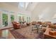 Bright living room with a high ceiling, skylight, french doors, and a decorative area rug at 6017 Chestatee Creek Nw Ct, Acworth, GA 30101