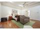 Bright and airy main bedroom featuring tray ceiling, hardwood floors, and a cozy seating area at 6017 Chestatee Creek Nw Ct, Acworth, GA 30101