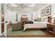 A well-lit main bedroom boasts a tray ceiling, natural light, and hardwood floors at 6017 Chestatee Creek Nw Ct, Acworth, GA 30101