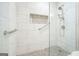 Close-up of a tiled shower with a glass door, showcasing the modern fixtures and design elements at 6017 Chestatee Creek Nw Ct, Acworth, GA 30101