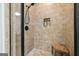 A tiled shower features a built-in bench and a shower niche for toiletries at 6017 Chestatee Creek Nw Ct, Acworth, GA 30101