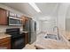 Kitchen with stainless steel appliances, wooden cabinets, and a view to the living room at 2714 Haynescrest Dr, Grayson, GA 30017