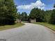 Gated entrance with stone columns and manicured landscaping, providing privacy and an elegant arrival at 4309 Giverny Blvd, Fairburn, GA 30213