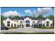 Elegant home with a circular driveway, manicured landscaping, and a striking architectural design at 4309 Giverny Blvd, Fairburn, GA 30213