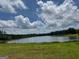 Scenic lake view framed by lush greenery and a vibrant blue sky, perfect for nature enthusiasts at 4309 Giverny Blvd, Fairburn, GA 30213