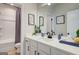 Neutral toned bathroom featuring a large mirror, white cabinets and a tub with a shower at 4484 Eastbrook Pl # 54B, Snellville, GA 30039