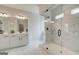 A modern bathroom featuring a double sink vanity, framed mirror, and a glass-enclosed shower with decorative tile at 4484 Eastbrook Pl # 54B, Snellville, GA 30039